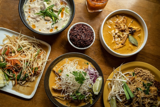 A variety of staple Thai dishes served on a table