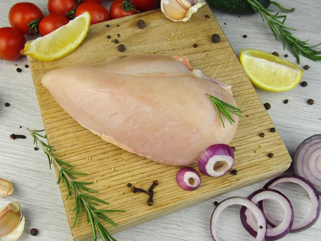 Raw chicken fillet on a wooden cutting board