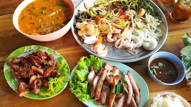 An assortment of Thai dishes laid out on a table