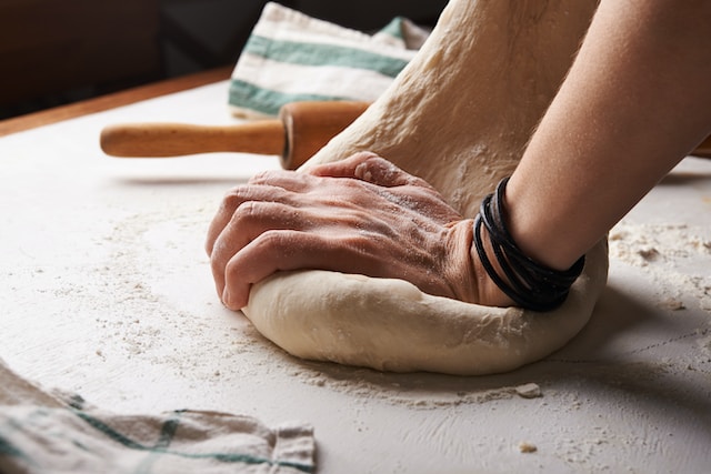 A hand kneading a dough