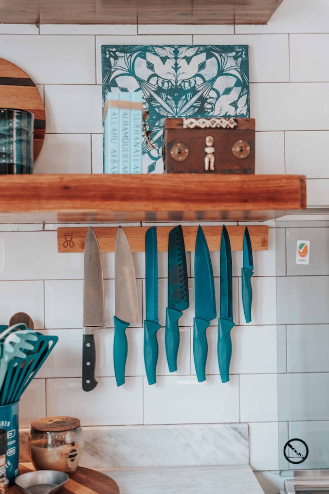 An assortment of kitchen knives on the wall