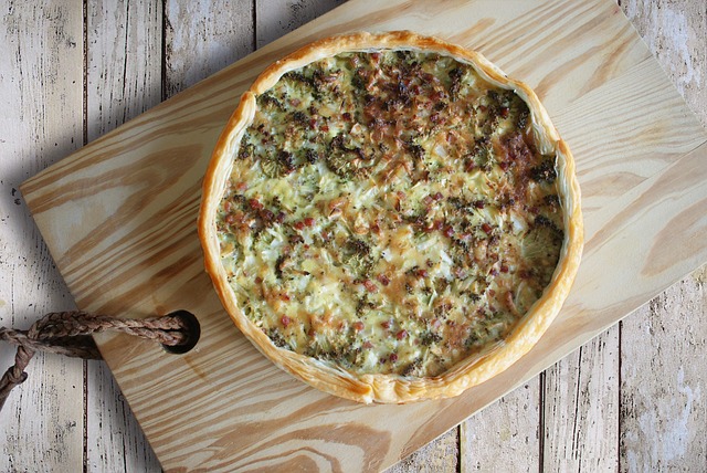 Quiche on a wooden chopping board