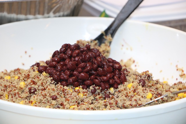Quinoa and black beans in a white mixing bowl