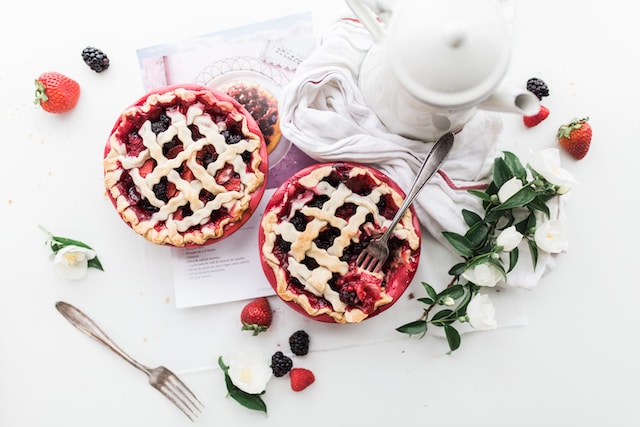 Two servings of blackberry and strawberry pie
