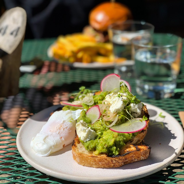 Avocado on a toast with poached egg on the side