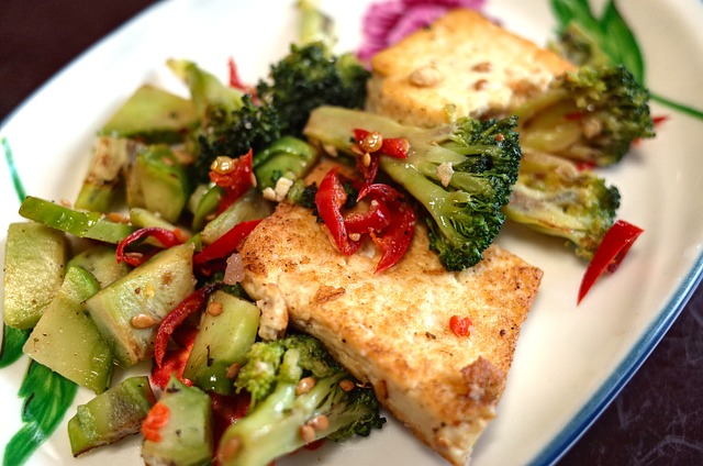 Stir-fried tofu with assorted vegetables on a white ceramic plate