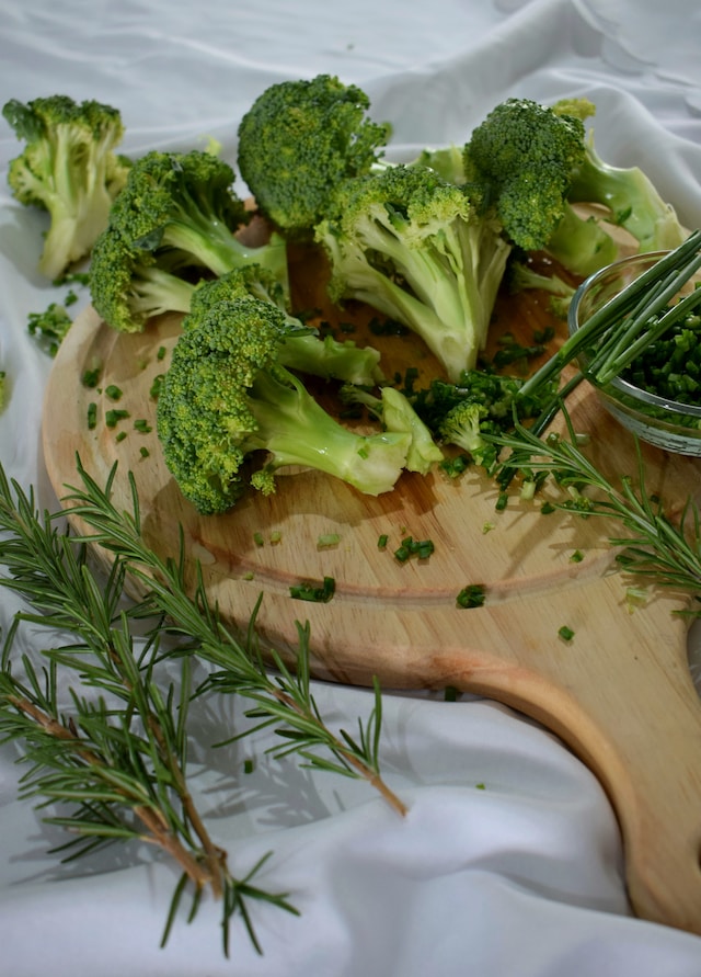 Broccoli and rosemary on a chopping board