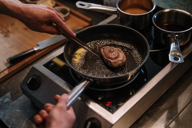 Steak cooking in a skillet