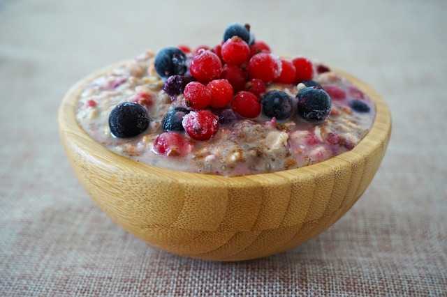 Pats with assorted berries on top in a wooden bowl