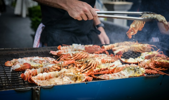 Person grilling lobsters