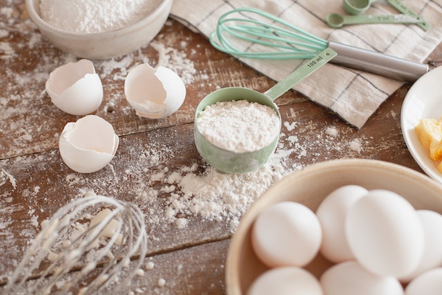 baking ingredients and tools on a floured table top