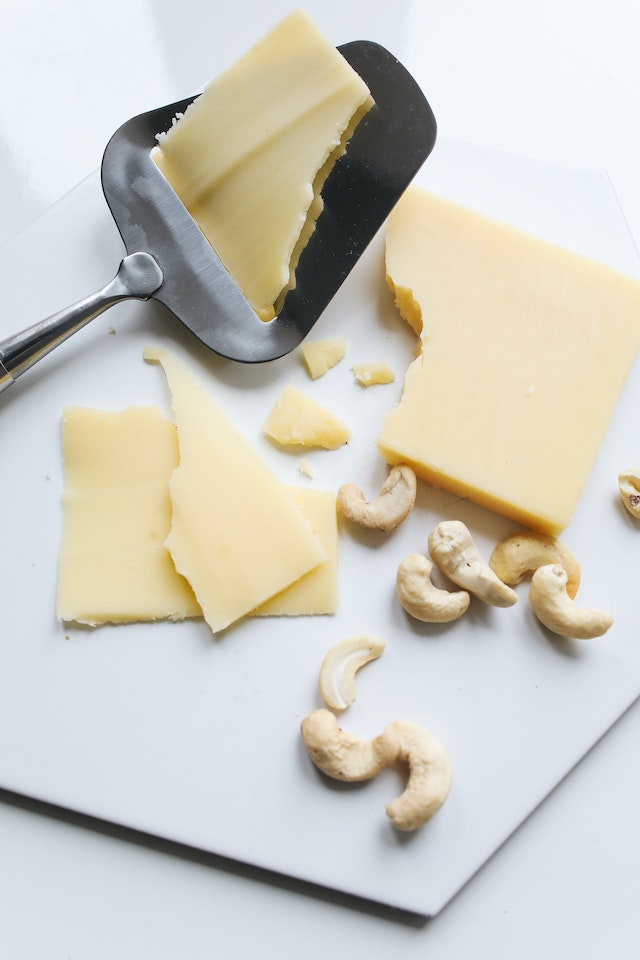 Slices of cheese with cashews
